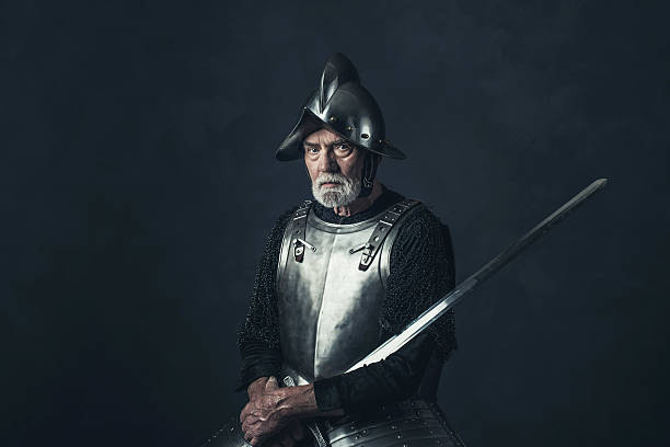 istock Senior knight in armor holding sword. 542564732