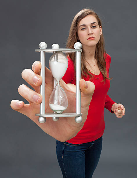 istock severe young woman provoking in holding a bullying egg timer 542565000