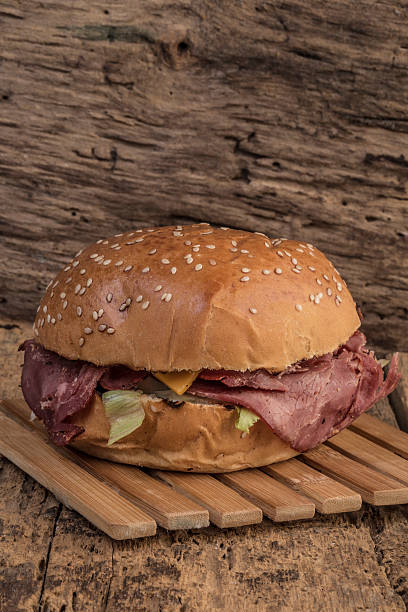 istock roast beef burger on wooden table 542566784