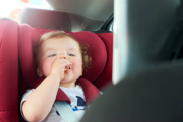 istock Baby boy in car seat watching DVD 542567864