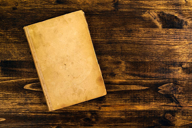 istock Old vintage book on rustic wooden table 542569208