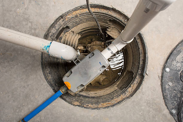 Backup Sump Pump - Overhead A sump pump installed in a basement of a home with a water powered backup system. water pump photos stock pictures, royalty-free photos & images