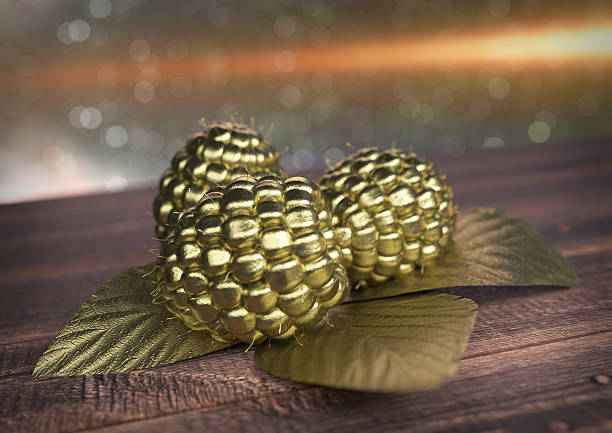 Golden Raspberry on wooden desk - 3D render