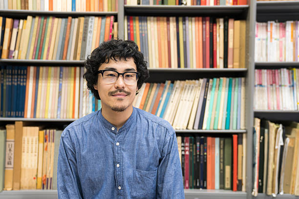 istock Researcher in front of bookshelf in a library 542571442