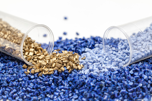 plastic granules, blue and gold close up