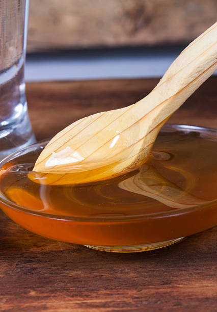istock honey closeup with wooden spoon 542575686