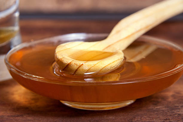 istock honey closeup with wooden spoon 542575738