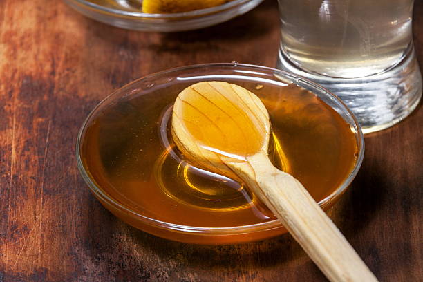 istock honey closeup with wooden spoon 542575804