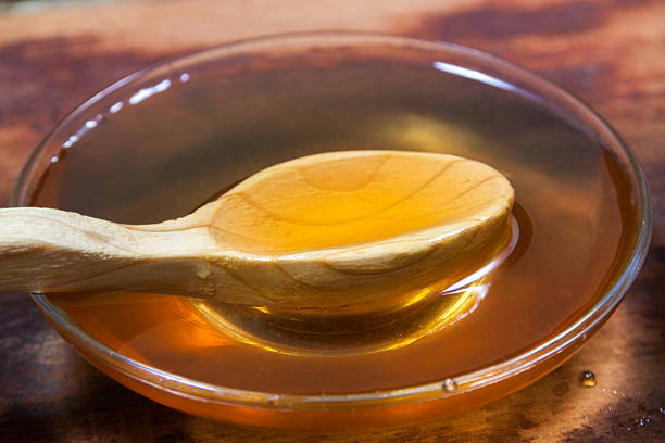 istock honey closeup with wooden spoon 542575852