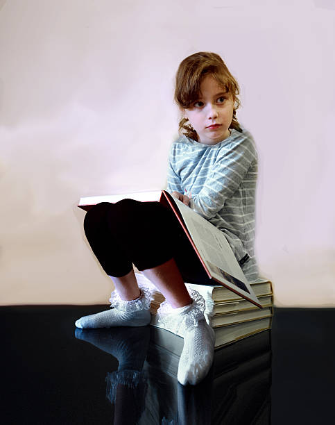 istock beautiful little girl with a book 542575992