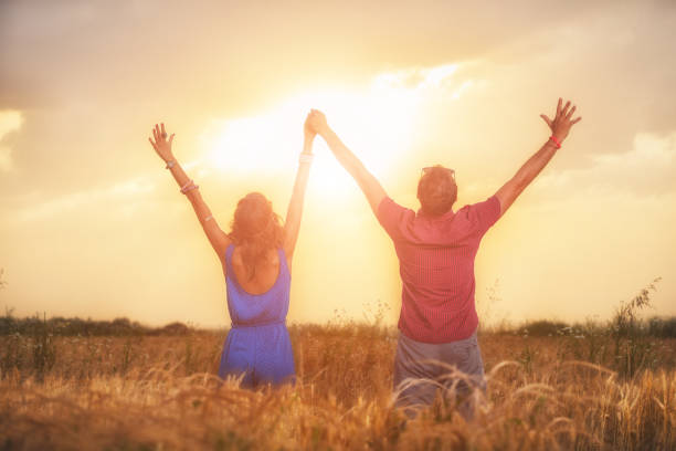 Couple enjoying outdoors in a wheat field.