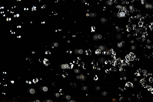 istock Water drops fly in the air with defocused lights on 542577372