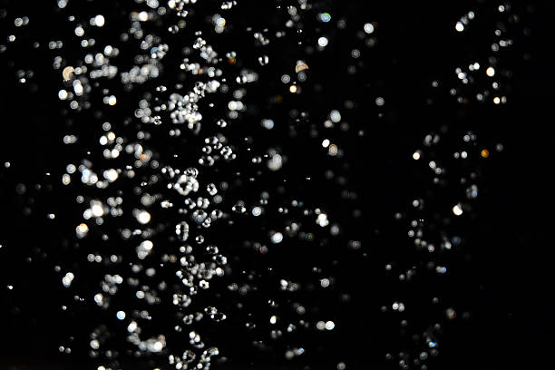 istock Water drops fly in the air with defocused lights on 542577748