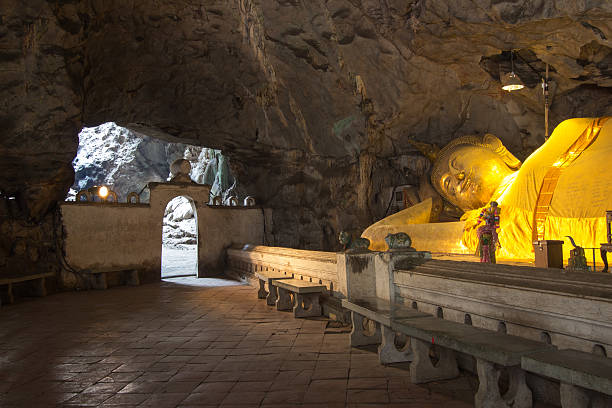 istock huge reclining Buddha image in Khao Luang Cave,Phetchaburi,Thailand. 542578972