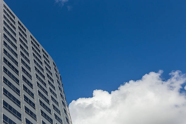 istock Modern office Skyscrapers on the blue sky with clouds 542580354