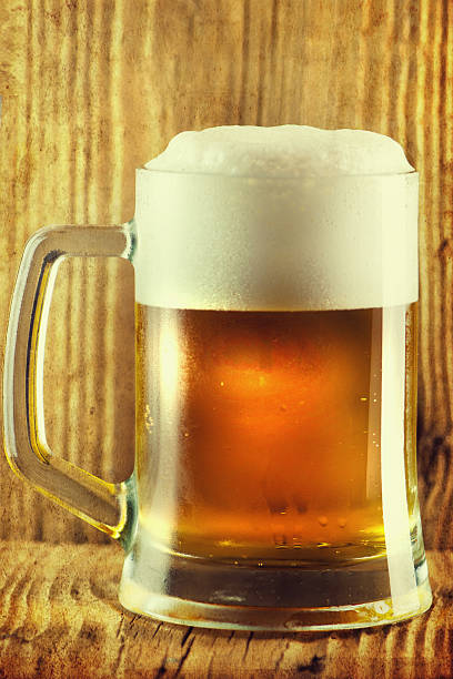 istock Beer by the glass on a wooden background. 542581256