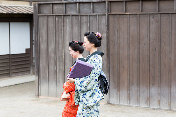 istock Two Beautiful Japanese Woman in Kimono waking, talking 542582392