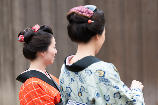 Two Beautiful Japanese Woman in Kimono are waking, talking in Edo Period Town
