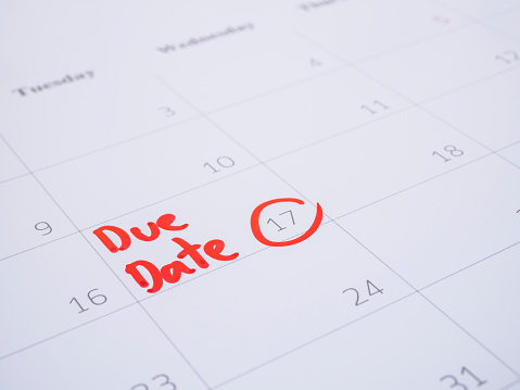 Close up handwriting word Due Date on calendar desk (Selective focus)