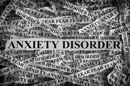 Anxiety Disorder. Torn pieces of paper with the words Anxiety Disorder. Concept Image. Black and White. Closeup.