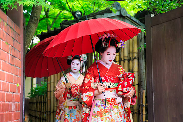 istock Maiko girls walking in narrow path with umbrella 542585268