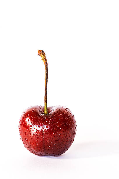 istock Isolated fresh cherries on wooden table 542586574