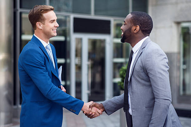 istock Pleasant colleagues shaking hands 542586634