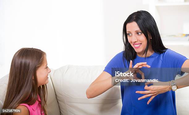 Smiling Deaf Girl Learning Sign Language Stock Photo - Download Image Now - Sign Language, Discussion, Talking