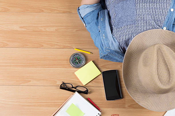 istock woman lying on floor with hat, mobile phone, notebook 542592452