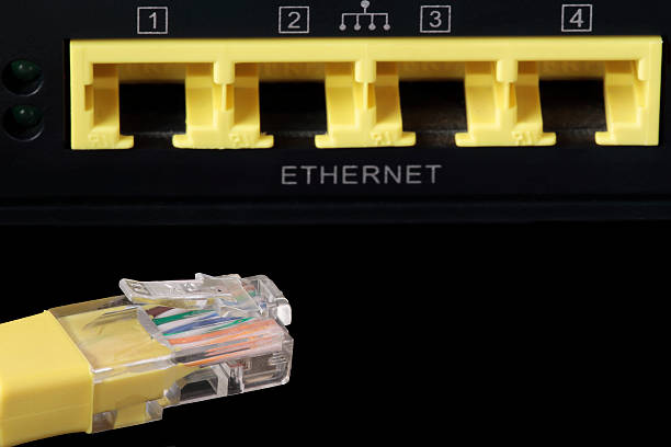 istock foreground of a yellow network cable and four network ports 542595486
