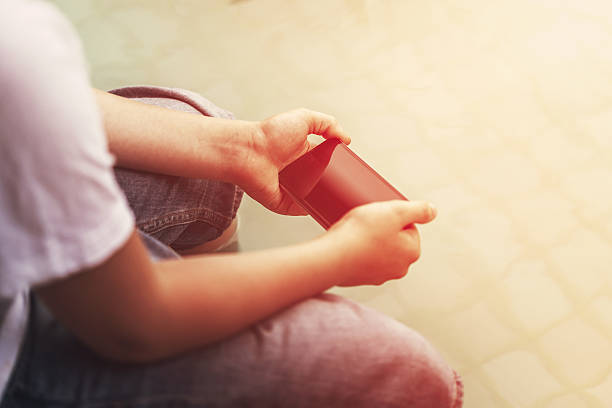 istock Man uses a smartphone sitting near pool 542681234
