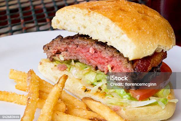 Delicious Hamburger With Fried Potatoes Stock Photo - Download Image Now - Rare - Cooking Technique, Hamburger, Snack