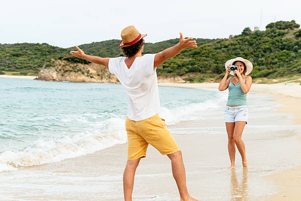 istock Image of cheerful couple on beach taking photos 542685188