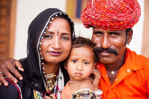 Portrait of a young Indian Family in traditional attire in Pushkar, Rajasthan, India.