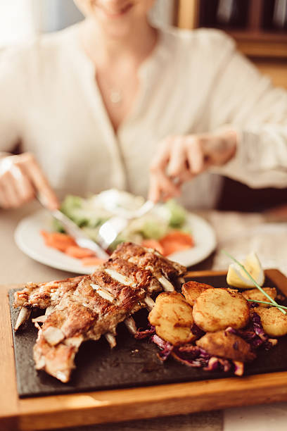 istock Smiling woman eating in restaurant 542690694