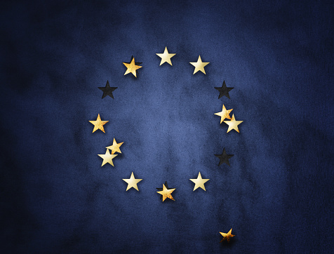 EU exit concept with falling stars on blue background.