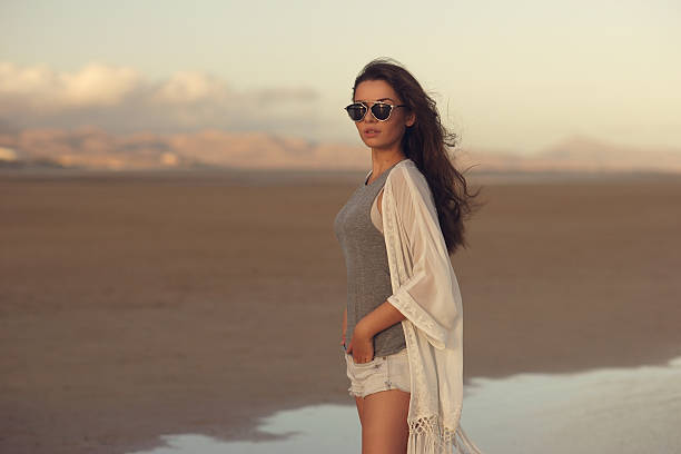 istock woman at sunset beach 542691120