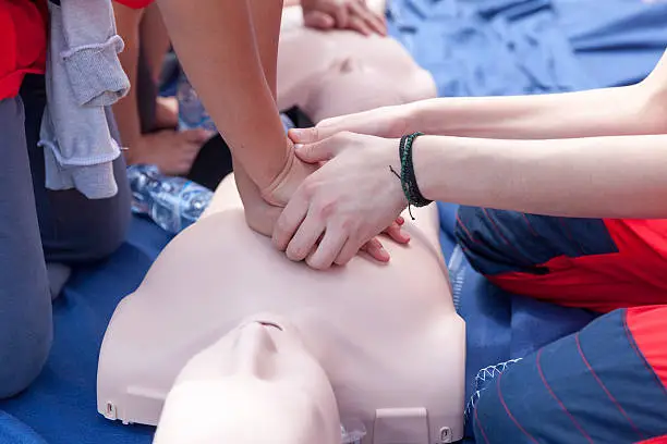 Cardiopulmonary resuscitation (CPR) being performed on a medical-training manikin