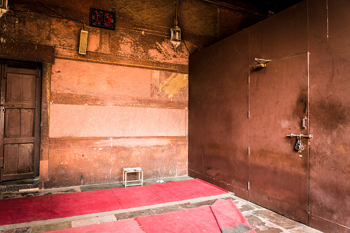 Background of living room interior of an abandoned communal apartment, dirty room, rotten peeling walls. Old past of poor, cuffed floor, tripped wallpaper on wall. Repair concept. Copy ad text space