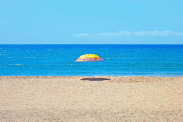 sea; beach; sky; blue; background; sand; umbrella; sandy beach; white; summer; travel; cyan; turquoise; ocean; horizon; vacation; island; copy space, beautiful; nature; tropical; beauty; sandy; water; day; landscape; outdoor; tourism; hot; waves; resort; paradise; Indian Ocean; surge; Caribbean; coast; Africa; relax; bay; tropic; Southern Africa; East Africa; Asia; tropics