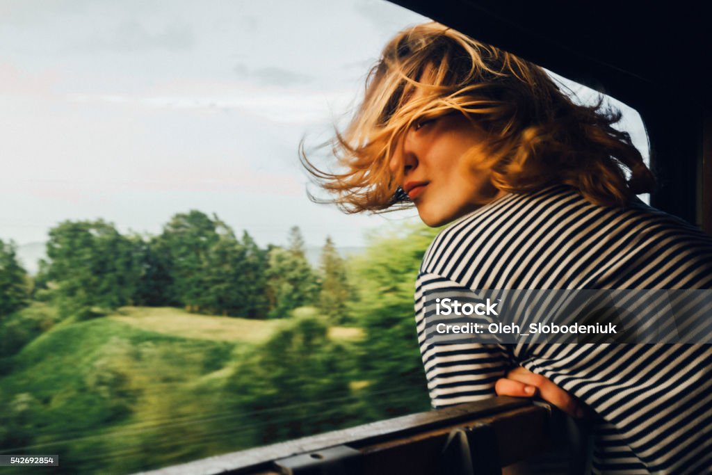 Woman looking at the view from train Caucasian woman looking at the view from train window  Train - Vehicle Stock Photo