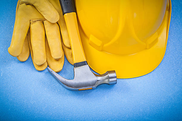 istock Composition of claw hammer safety gloves hard hat on blue 542693520