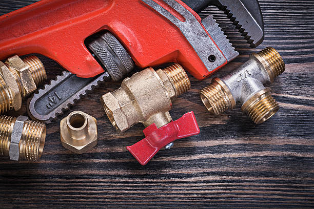 istock Composition of plumbing tools on wooden board horizontal version 542693620
