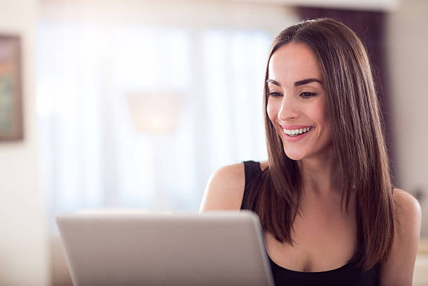 istock Adorable woman holding laptop 542694126
