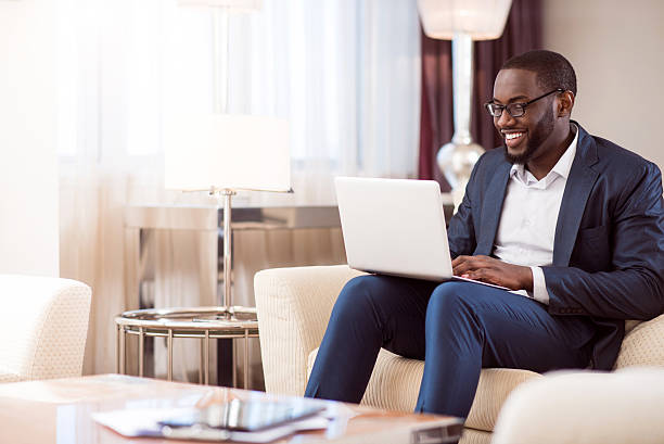 istock Man working on laptop in hotel room 542694260