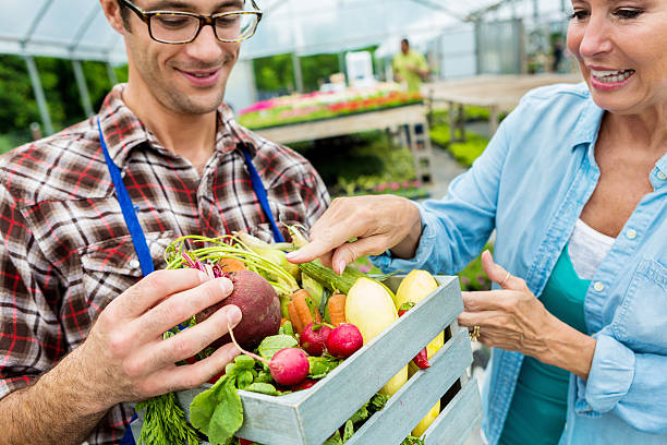 istock Female customer talks with farmer about organic produce 542694684