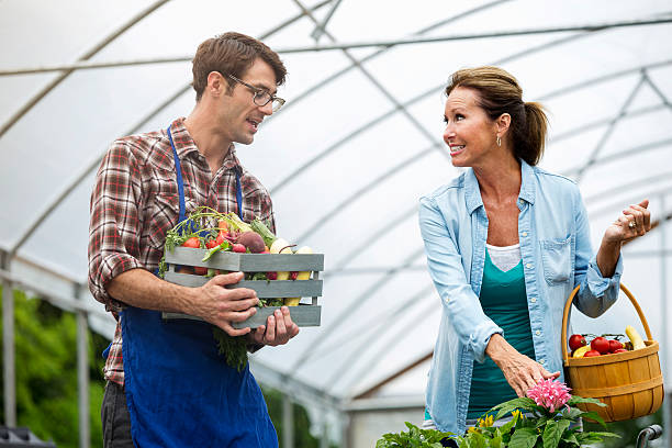istock Senior shopper and farmer picking out produce 542694748