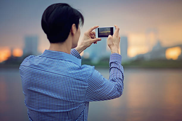 Young Japanese man is  taking photo