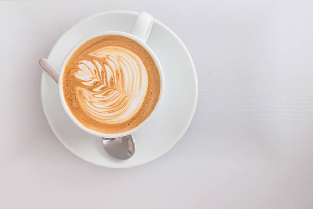 white cup of hot cappuccino art coffee on wooden table - cappuccino latté coffee high angle view imagens e fotografias de stock
