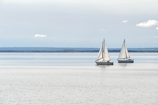 Two sailboats gliding along on Lake Superior, recreation and leisure image, lots of copy space for background uses.